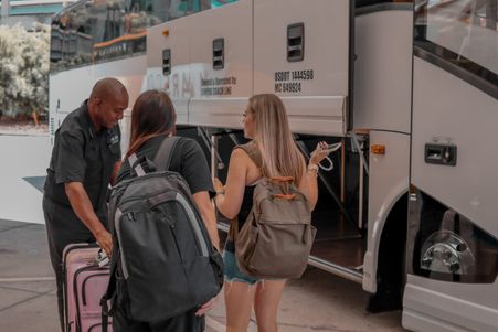 Two customers being assisted with their luggage at Mears Connect